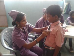 SSVS volunteer checking a young boy's heartbeat with stethoscope