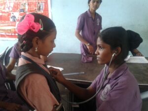 Female student using stethoscope under SSVS health awareness event